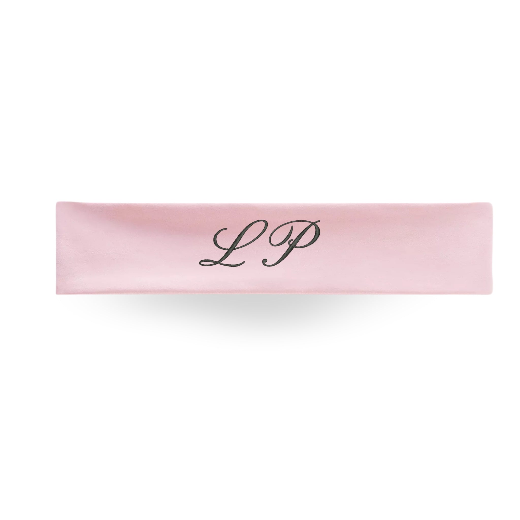Pink personalized headband with elegant 'LP' monogram, ideal for casual wear and workouts.