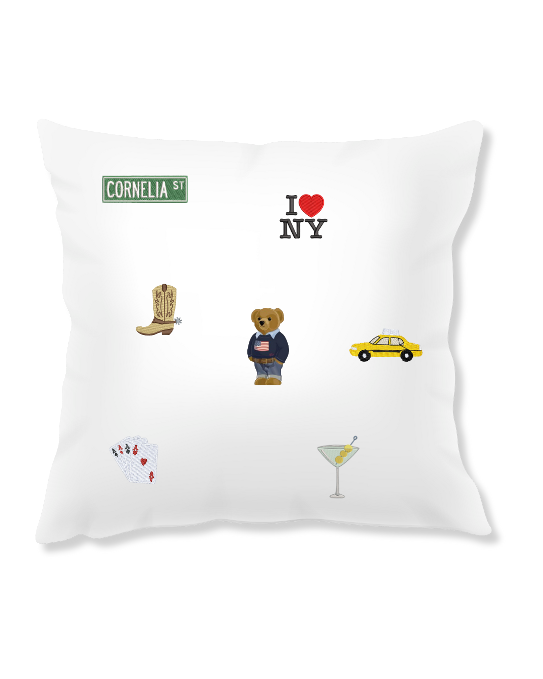 Decorative embroidered pillow with various icons including a street sign, heart, bear, taxi, and cocktail.