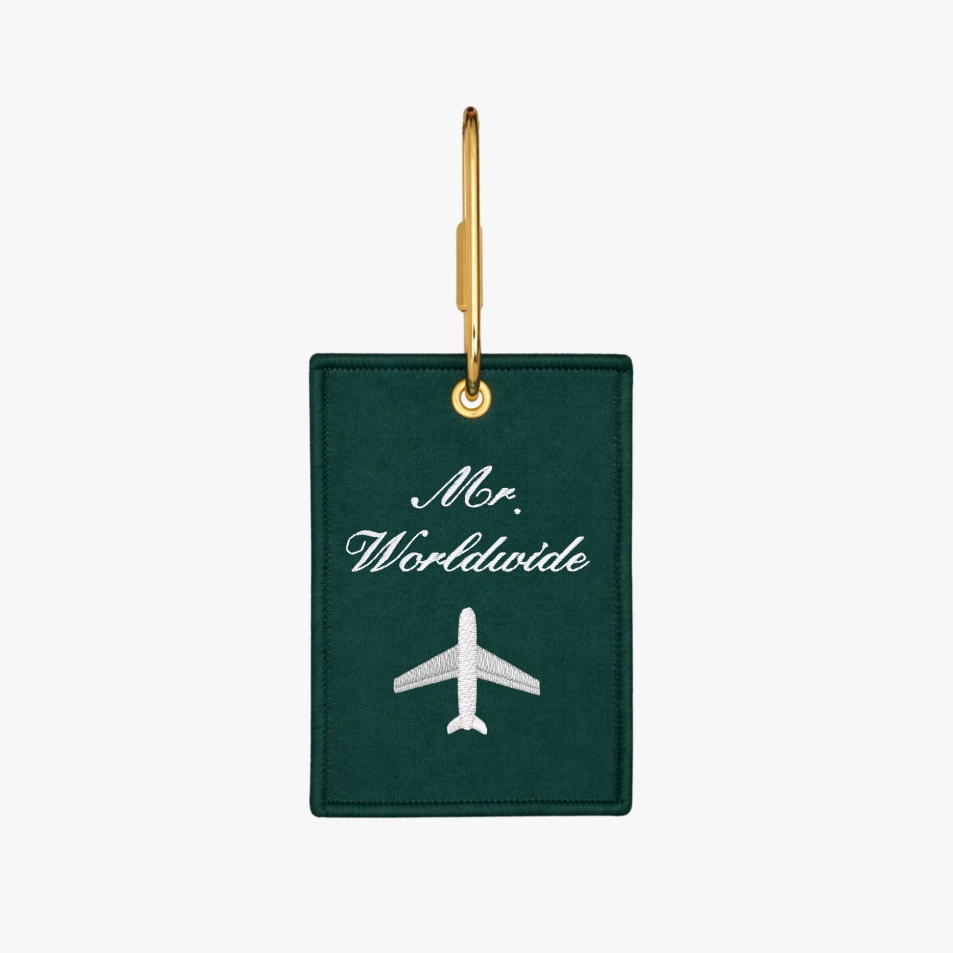 Embroidered Green luggage tag with 'Mr. Worldwide' and airplane icon on a green background