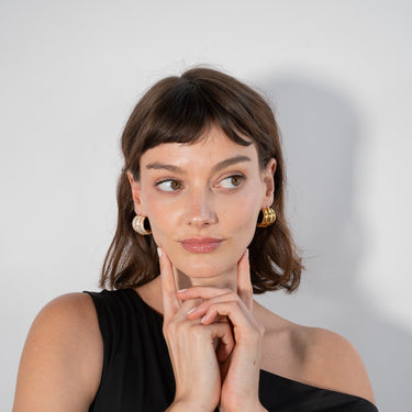 Women in black wearing the Pave Danish Earrings sold by Jullist